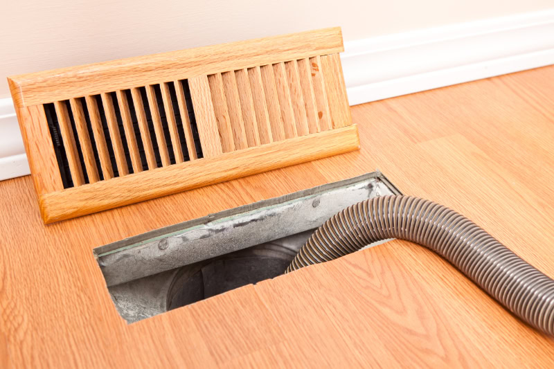 Why Air Duct Cleaning Is Important. Photo of a hose running into a vent for cleaning.